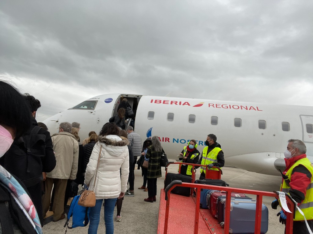 Students boarding a flight to Spain